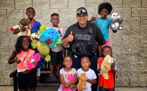 HCFD Officer with standing several kids