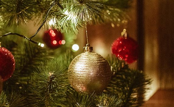 christmas tree with lights and red and gold ornaments
