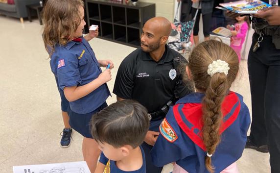 Officer kneeling with children