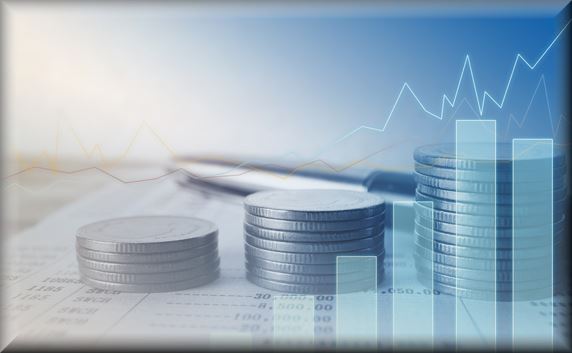 Coins stacked on a financial statement with a chart overlay