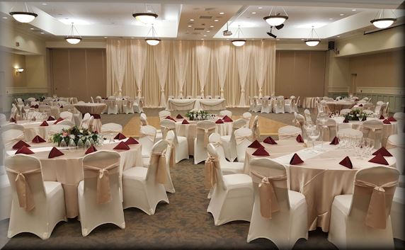 Tables and chairs in a banquet hall decorated for a wedding