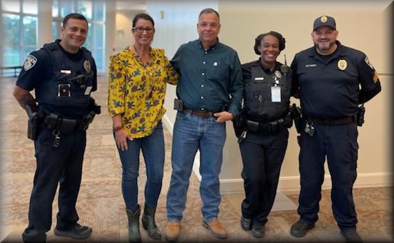 3 Police officers standing with 2 citizens
