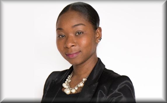 Female with black hair wearing a black jacket over a black blouse