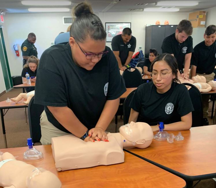 Emily Perez practices CPR on a dummy as part of the Polk County Sheriff’s Office’s Ride-Along