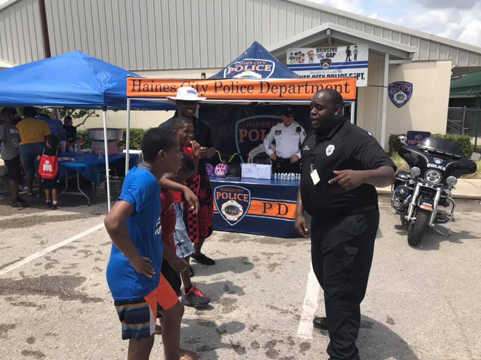 Officer Kalen Holmes interacts with a couple of youngsters during 