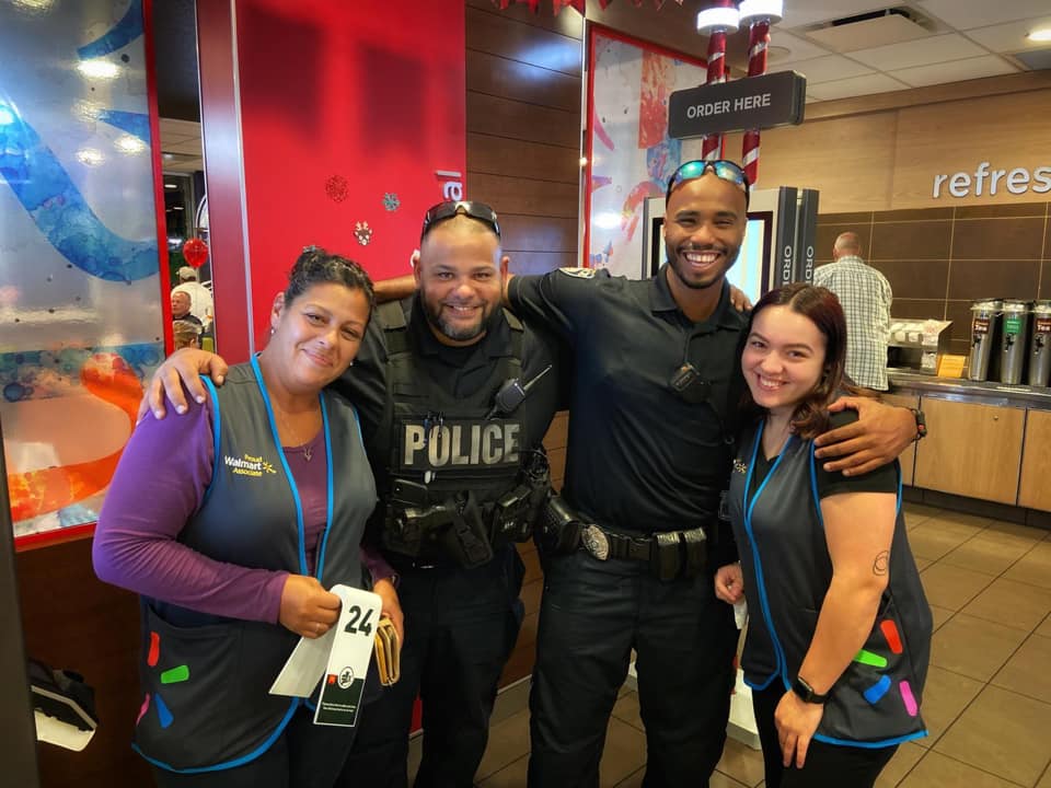 Officers Carlos Dominguez and Joel Morales smile with patrons at McDonald’s during a monthly 