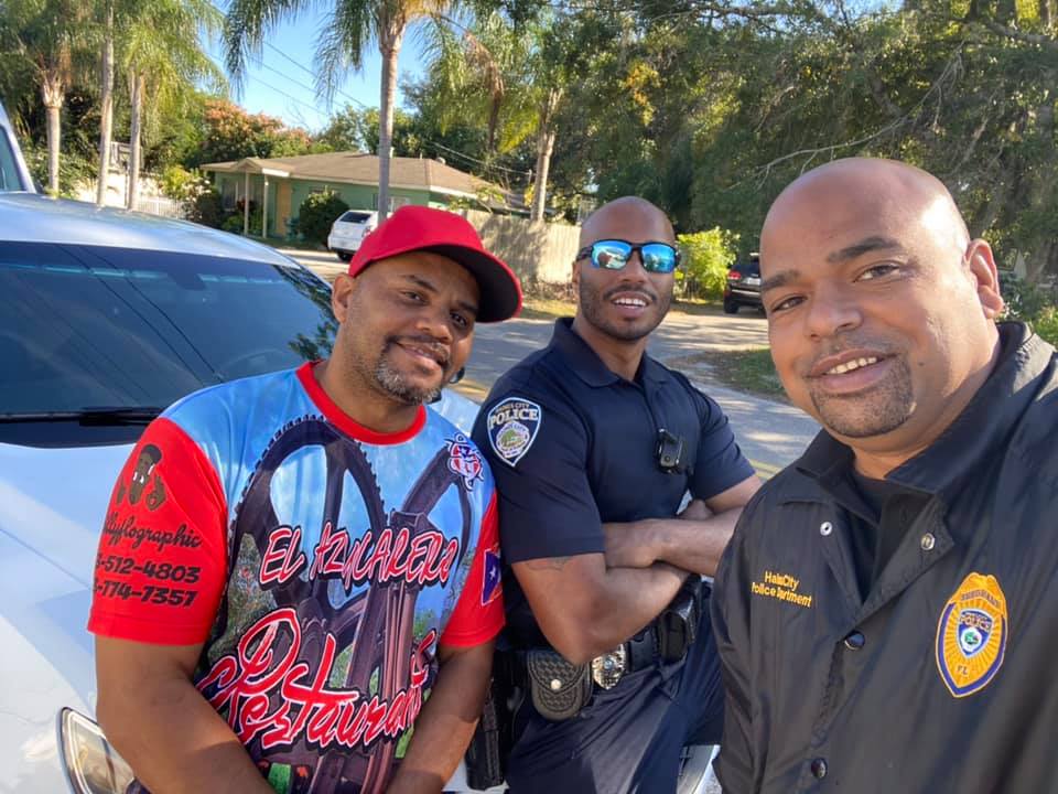 Officer Joel Morales (middle) and Sgt. Christopher Colon (right) welcome new business, El Azucarero 
