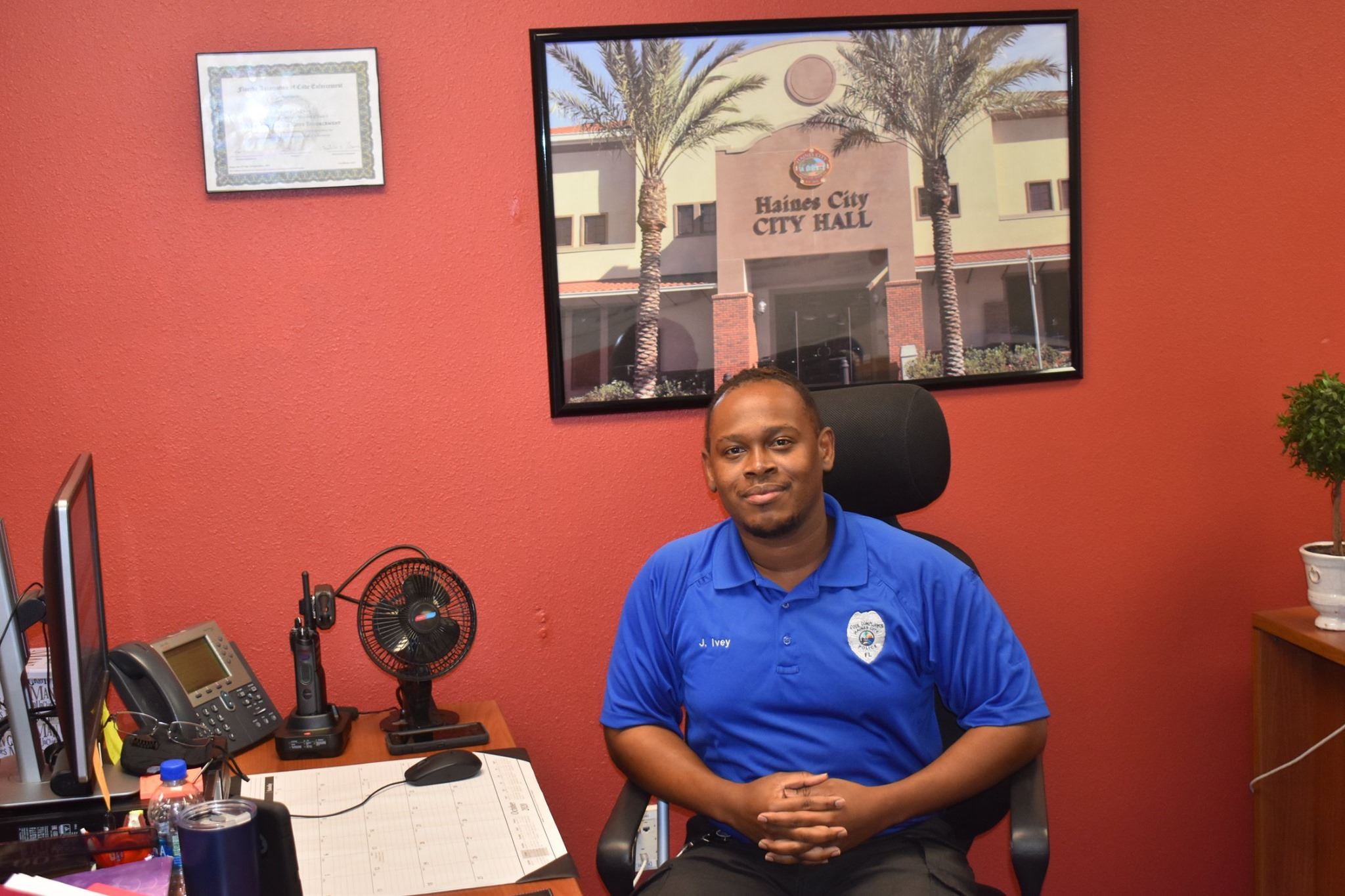 Code Compliance Officer Jerome Ivey sits at his desk inside the Haines City Police Department.