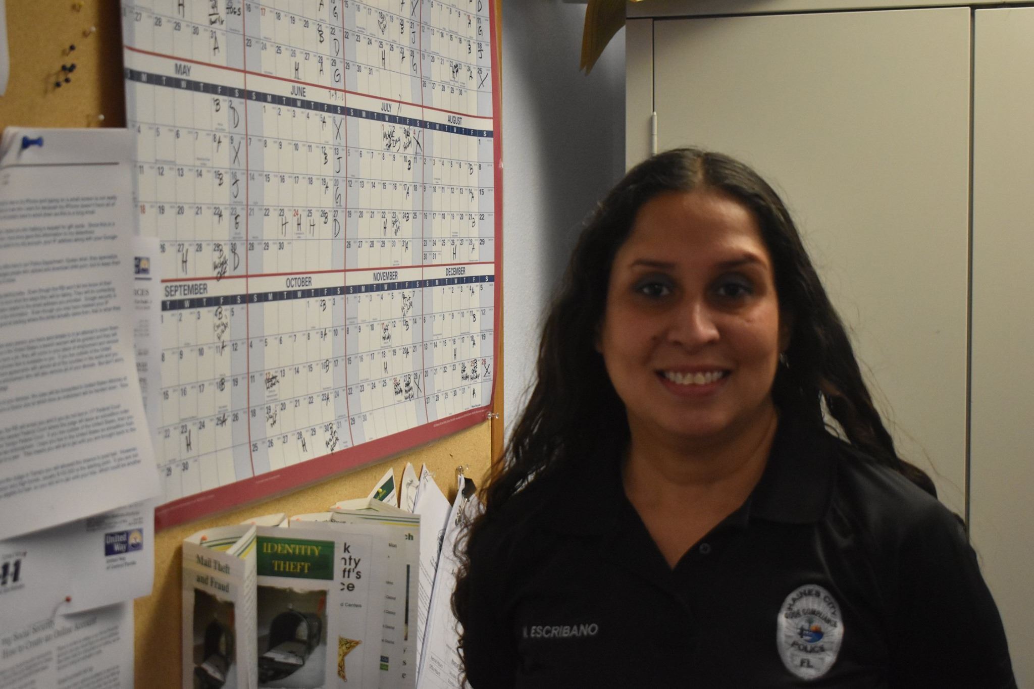 Michelle Escribano smiles in her office at the Haines City Police Department.