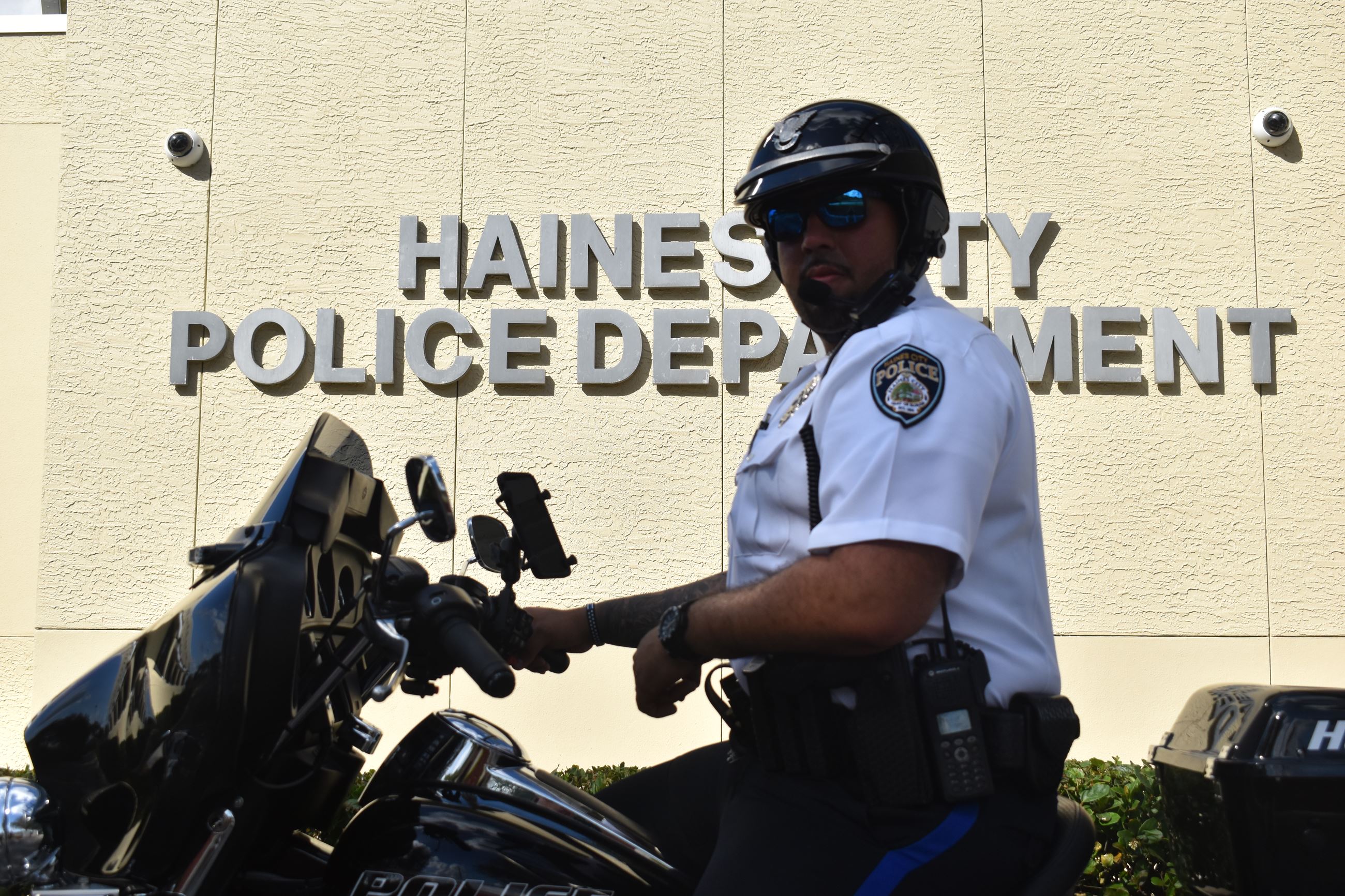 Edgardo Cruz Jr. rides his agency motorcycle outside the Haines City Police Department. 